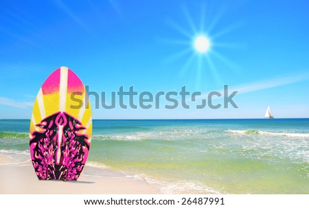 Surf board in sand at pretty beach