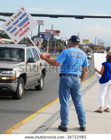 PENSACOLA, FLORIDA - SEPTEMBER 7: Concerned citizens hold signs to protest Healthcare Reform while standing along Davis Highway on September 7, 2009 in Pensacola, Florida.