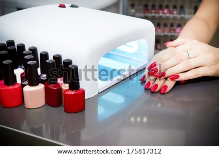 Manicure set in a beauty salon. Beautiful female hands.
