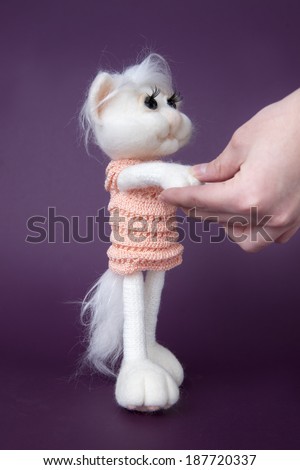 Toy white cat on purple background. Gift for holiday. Handmade Felt.