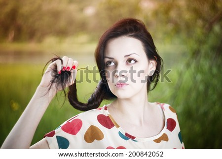 Portrait of a beautiful young woman in summer. Girl face closeup. Sunbeams.