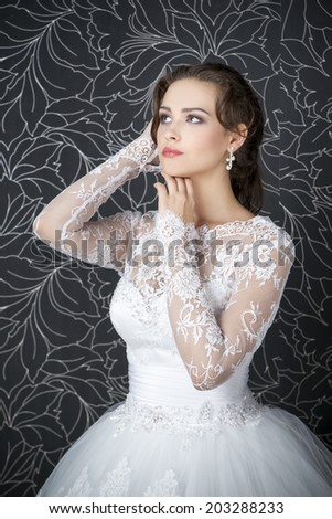 Beautiful woman in white wedding dress. Professional makeup hairstyle bride