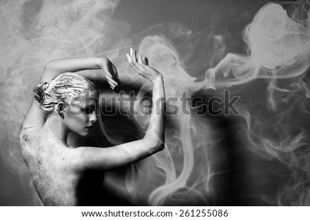 Portrait of the beautiful naked woman. Abstract smoke. Black and white photography. Body care. Spa. Mask of clay