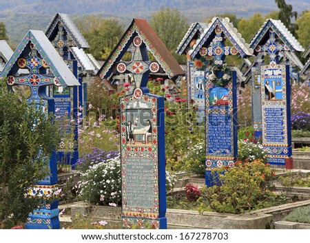 SAPANTA, ROMANIA - OCTOBER 03: Carved and painted wooden crosses in the Merry Cemetery. Part of UNESCO is visited by crowds of tourists every year. On October 3, 2013 in Sapanta, Romania.