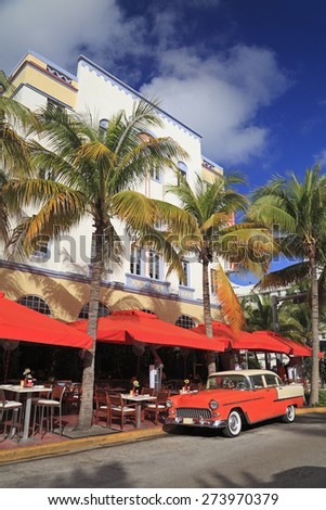 MIAMI BEACH, FL - DEC 30: Old car and restaurants on Ocean Drive, the major thoroughfare in the South Beach on Dec 30, 2014 in Miami Beach, FL, USA