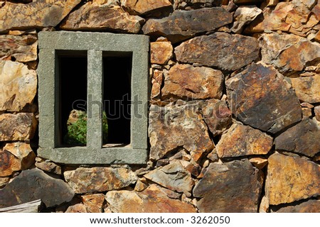 A colorful old stone wall with window in the southeast of China.