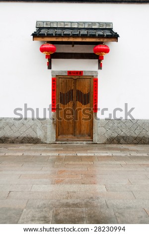Old-fashioned wooden door in China,decorated with  Chinese lanterns for Chinese New Year.