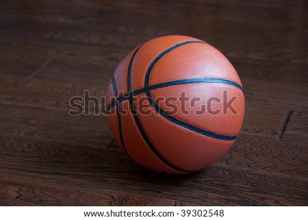 Basketball on the hardwood basketball floor in a stadium