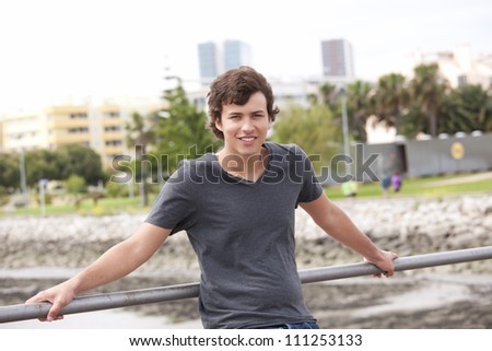 young man smiling at the park