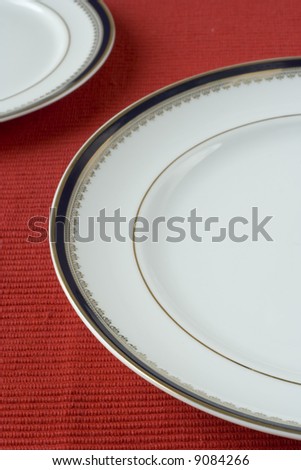 porcelain plates in a perspective over red (selective and soft focus)