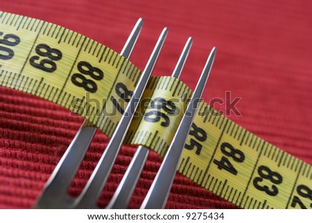 a fork and a measure tape, conceptual loose weight (soft and selective focus)