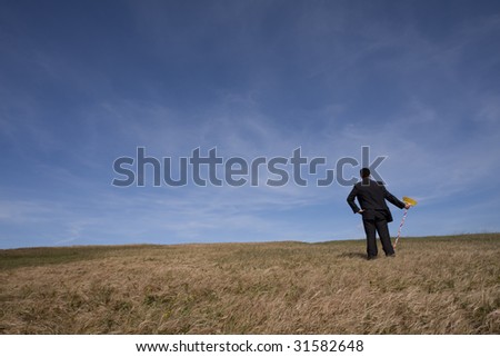 businessman cleaning the field with a broom