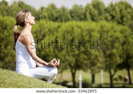 young woman enjoying nature in a yoga pose