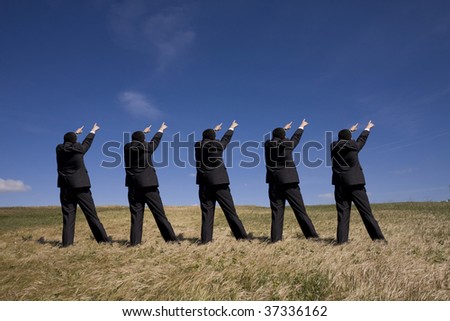 coordinated group of businessman pointing to the same side