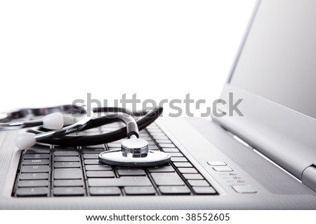 laptop with a stethoscope for good maintenance (selective focus)