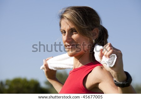 woman cleaning her sweat with a towel