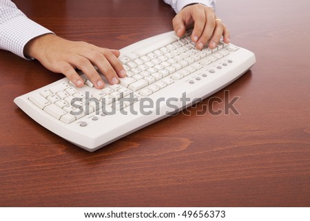 hands writing in the keyboard at the office