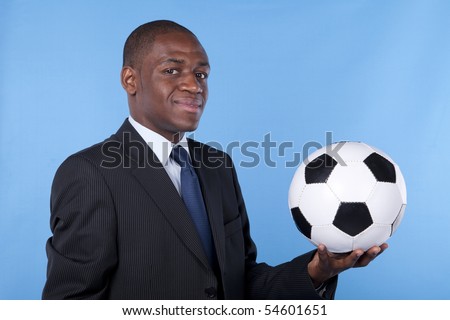 African businessman holding a soccer ball