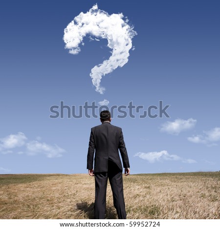 businessman standing alone at the field with a lot of questions in his mind