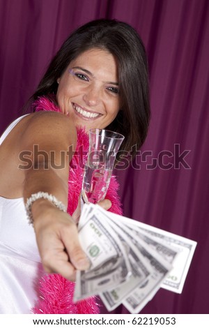beautiful woman celebrating the new year eve with champagne and lots of money