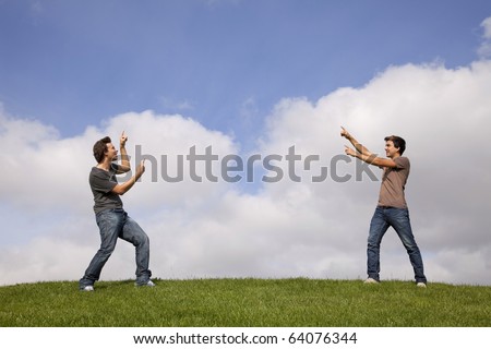 two young teenager pointing to the copy space between the two