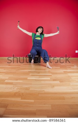 woman relaxing at her house after repairing her red wall