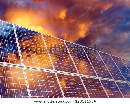 Solar battery on sunset sky background.