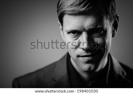 Handsome man portrait with an evil smirk