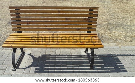 Wooden bench and the shadow in outside