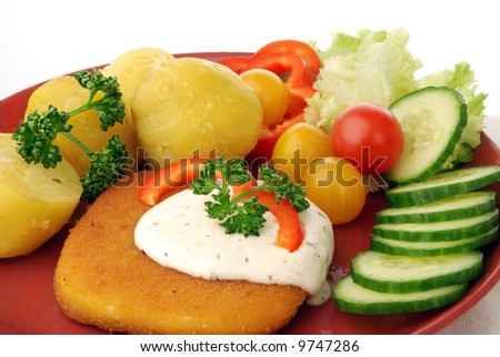 Serving of breaded cheese with potatoes and vegetable garnish