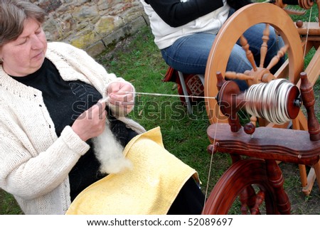 RATIBORICE, CZECH REPUBLIC - APRIL 24:  Older woman spinning wool on traditional spinning wheel - The Shepherds Festival 2010, chateau area on April 24, 2010 in Ratiborice, Czech Republic