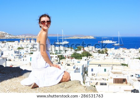 young woman wearing white dress in mykonos, greece