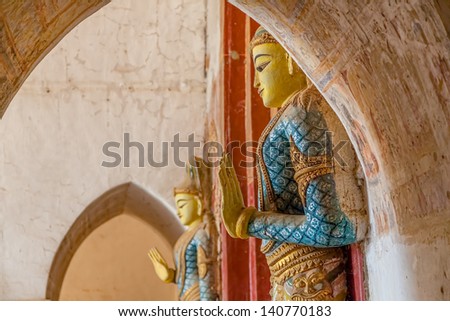 BAGAN, MYANMAR - FEBRUARY 23: Old wooden Door Guardian statue hand detail in front of the east entrance of the Ananda temple  on February 23, 2013 in Bagan, Myanmar.