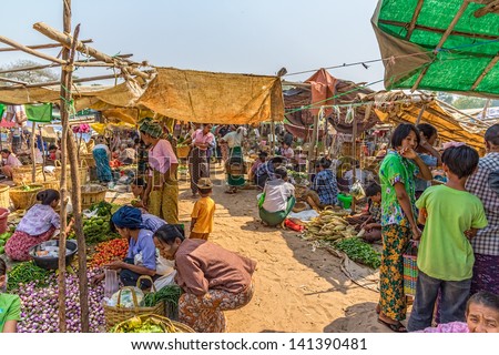 BAGAN, MYANMAR - FEBRUARY 24: Women are selling vegetables at the local market on February 24, 2012 in Bagan, Myanmar. All the food is organically grown.