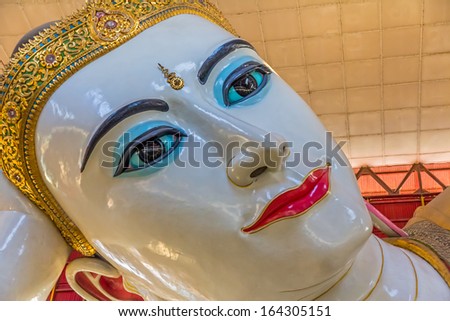 YANGON, MYANMAR - MARCH 1: The giant reclining Buddha close up of the head shows refinement of the work at Chaukhtatgyi temple on March 1, 2012 in Yangon, Myanmar.