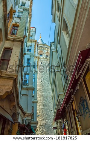 ISTANBUL, TURKEY - SEPTEMBER 28: View of the famous medieval landmark Galata Tower in the old narrow street in the city center on September 28th, 2013 Istanbul, Turkey.