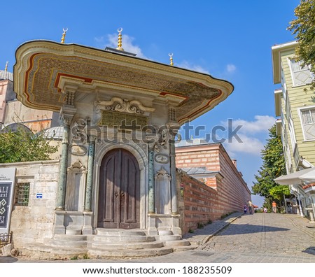 ISTANBUL, TURKEY - SEPTEMBER 27: Street of the Cold Fountain or Sogukcesme Sokagi with a decorated back entrance to the Hagia Sophia complex.