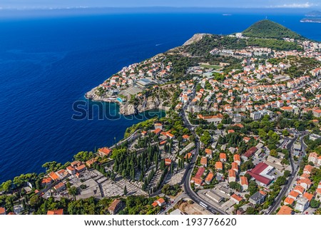 Aerial helicopter shoot of Dubrovnik new town. Residential area, hotels and cemetery.