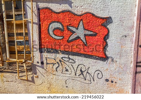 ISTANBUL, TURKEY - SEPTEMBER 28, 2013: Graphite Turkey flag on the wall of an old abandoned building in Phanar district.