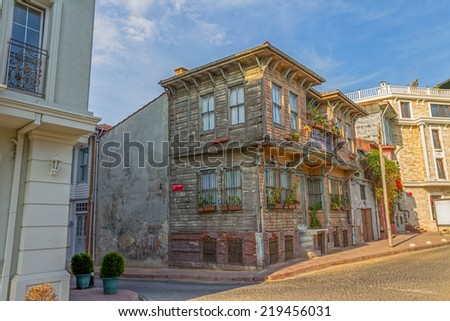 ISTANBUL, TURKEY - SEPTEMBER 27, 2013: Istanbul street with old traditional wooden houses and filigree sidewalk, Turkey. Golden Horn district.