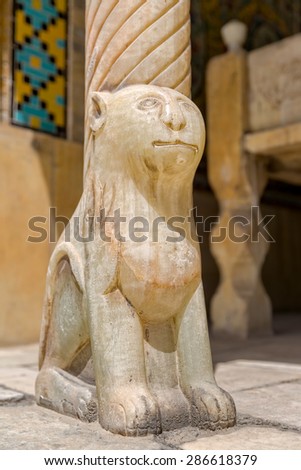 Lion on marble column base in Golestan Palace former royal Qajar complex in capital city. Tehran, Iran.