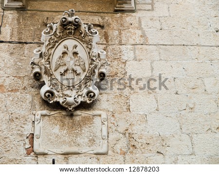 Wall relief on old house in town Trogir, Croatia. With copy space on right