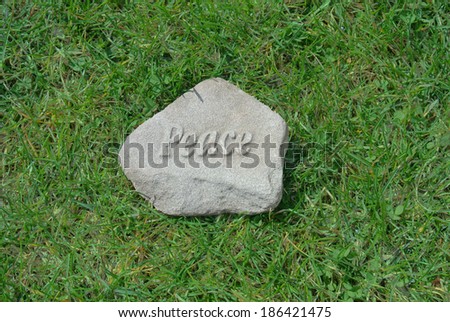 peace rock  garden stone on green grass garden in spring
