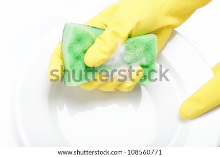 Hands in rubber gloves can sponge the plate on a white background.