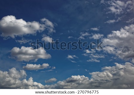 Blue sky with white cumulus clouds.