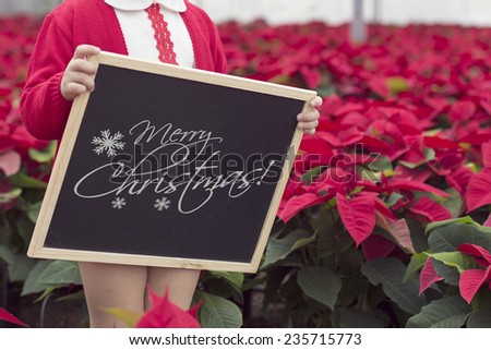 Black chalkboard with various winter decorations, text space and boy children