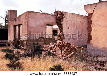 an old farm house lays in ruins and falling apart