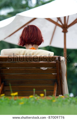woman resting on beach chair