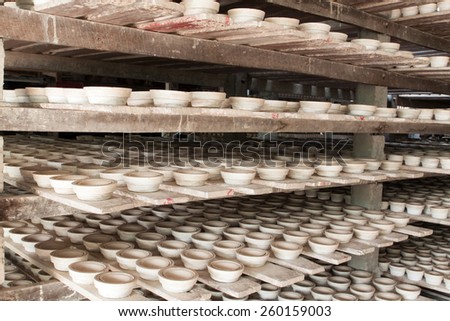 Ceramic cup in rack  prepare for bring in furnace in factory