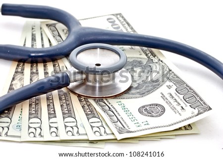 medical treatment and cost concept: stethoscope placing on US dollar banknotes on white background